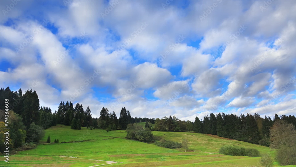 Fast cloud movement above green hill and forest, timelapse Fast cloud movement above green hill and forest, timelapse