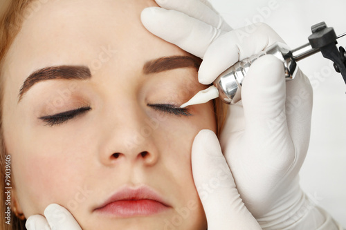 Cosmetologist making perman...