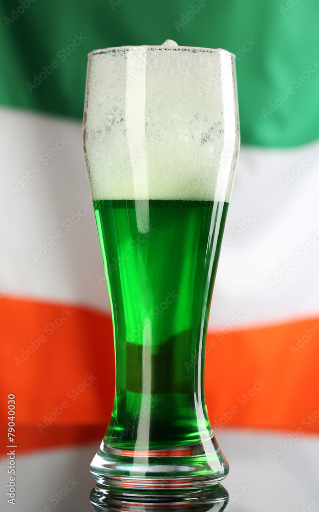 Glass of green beer on flag background Glass of green beer on flag background
