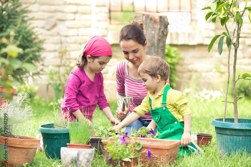 Children are helping their mother gardening