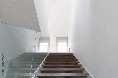 wooden staircase and glass balustrade