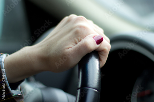 female hand on the steering wheel