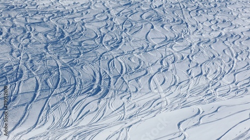 Snowboard and ski tracks in powder snow