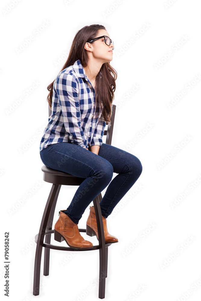 Fototapeta premium Young woman sitting on a chair