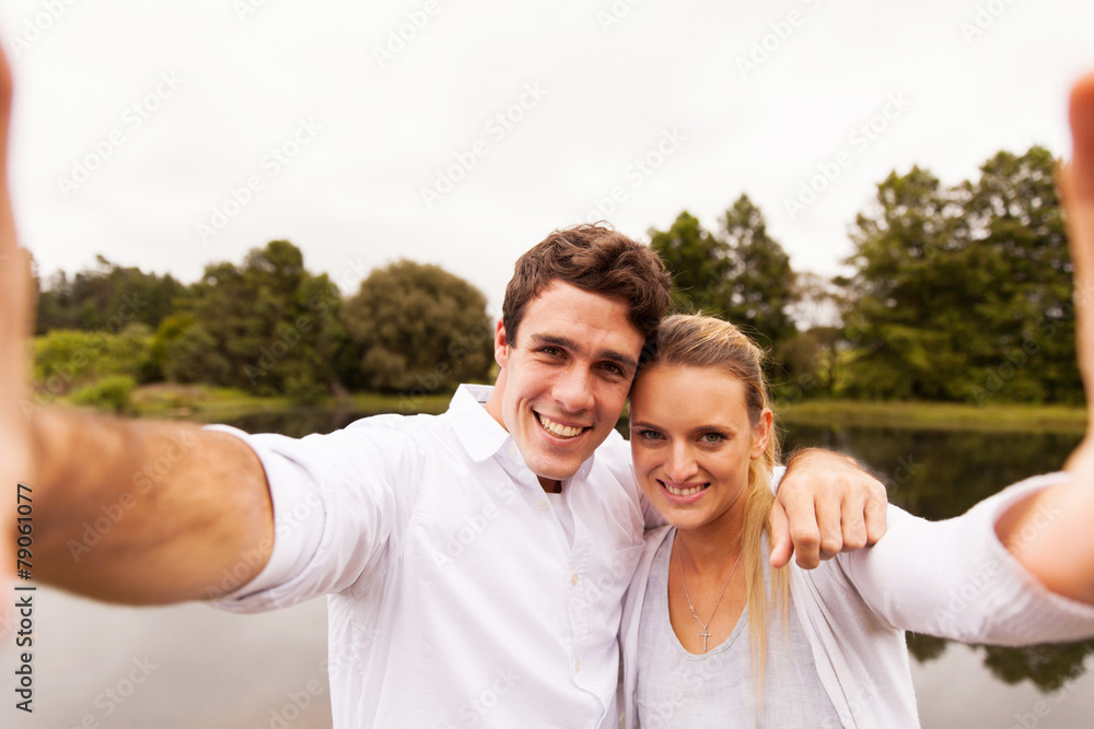 couple taking selfie together by the lake couple taking selfie together by the lake