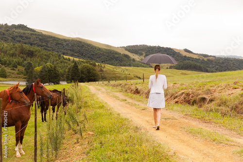 young woman walking on farm road