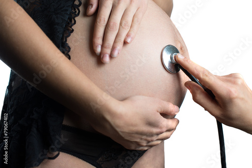 belly of pregnant woman and stethoscope