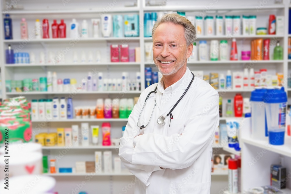 Pharmacist in lab coat with stethoscope and arms crossed Pharmacist in lab coat with stethoscope and arms crossed
