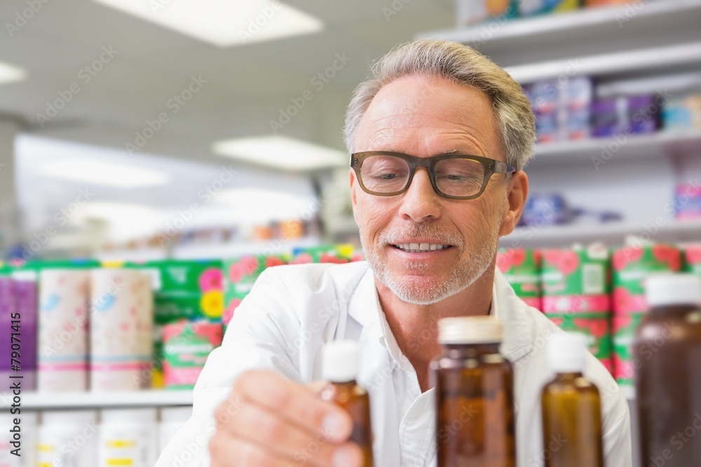 Senior holding and looking at jar of medicine Senior holding and looking at jar of medicine