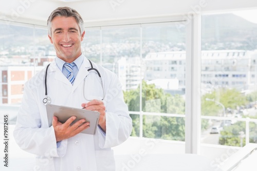 Doctor writing on clipboard