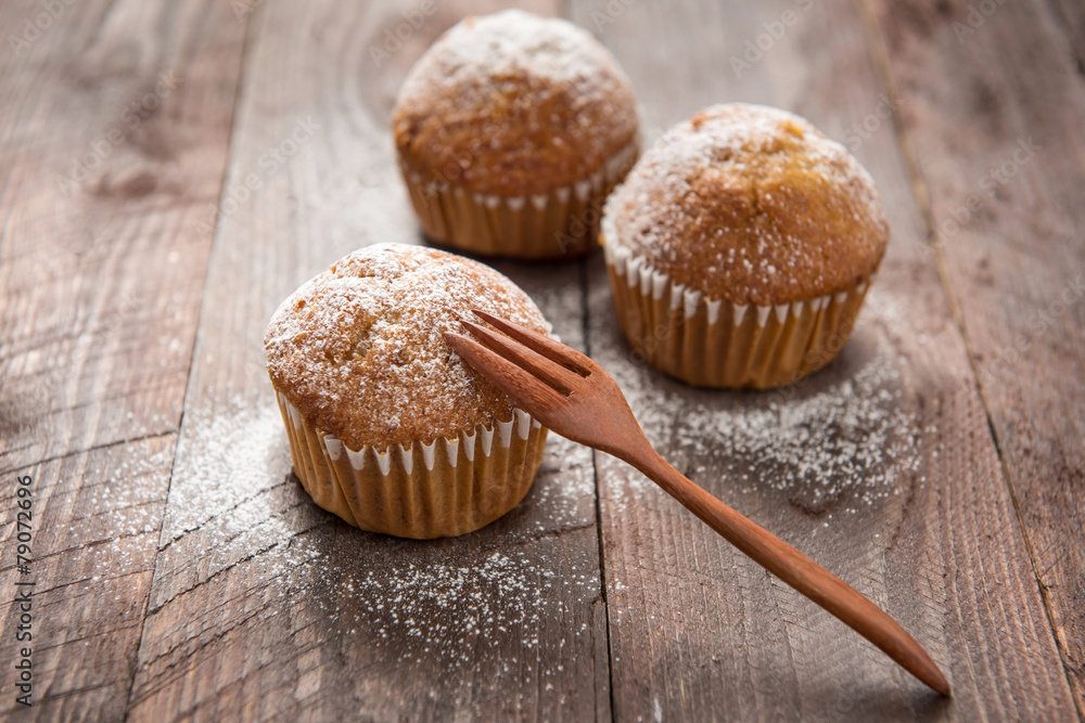 muffins and fork on a wooden table muffins and fork on a wooden table