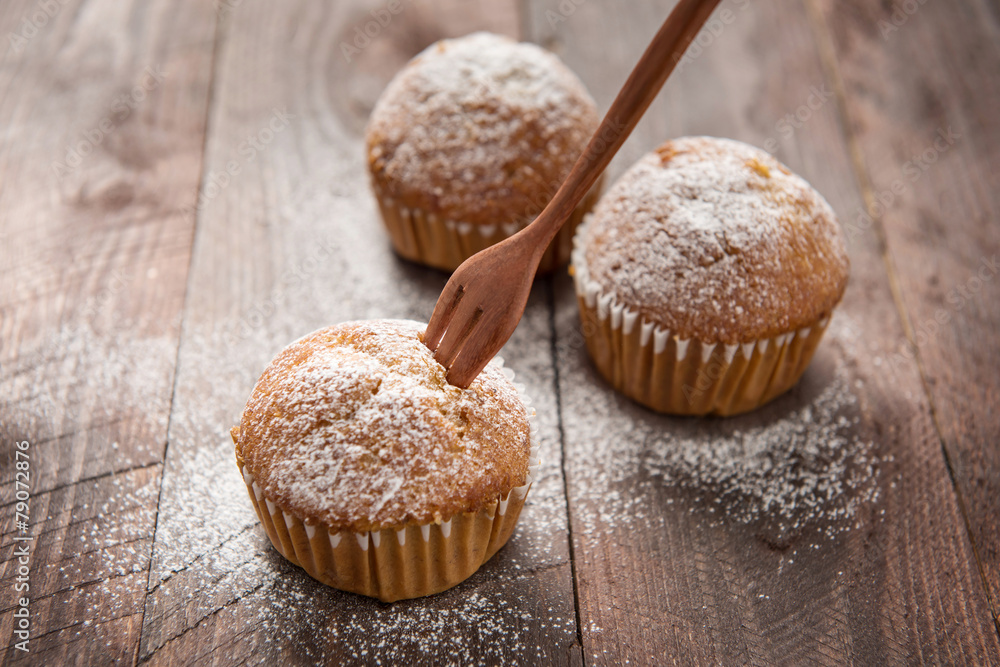 muffins and fork on a wooden table muffins and fork on a wooden table