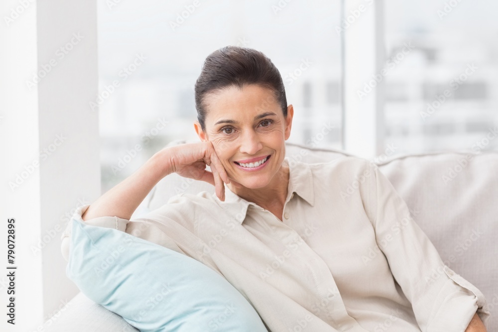 Portrait of happy woman relaxing on sofa Portrait of happy woman relaxing on sofa