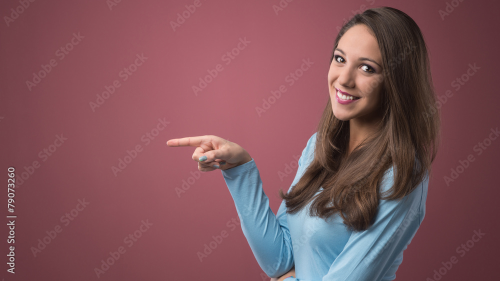 Smiling woman pointing left Smiling woman pointing left
