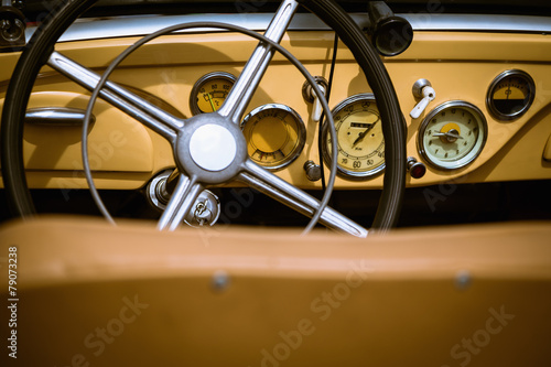Steering wheel with dashboard and in retro car interior © xmagics