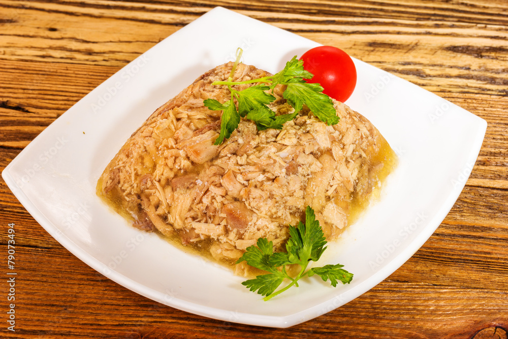 jellied minced meat served on a white ceramic plate