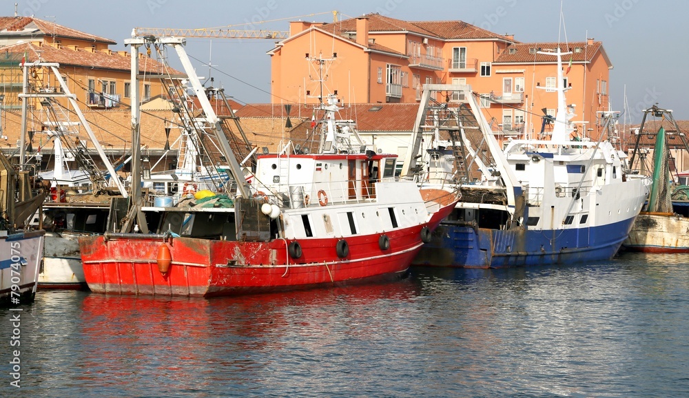 red fishing vessel moored in the harbor of the Mediterranean Sea