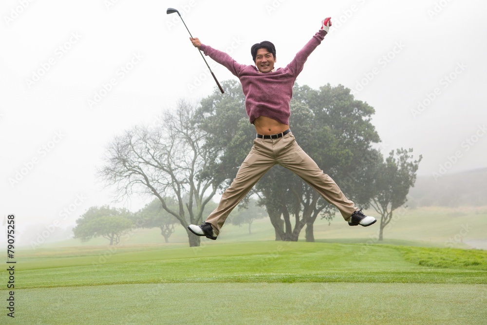 Excited golfer jumping up and smiling at camera Excited golfer jumping up and smiling at camera