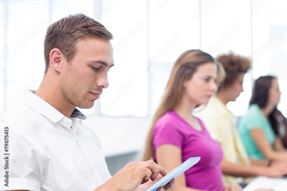 Fototapeta premium Male student using digital tablet in computer class