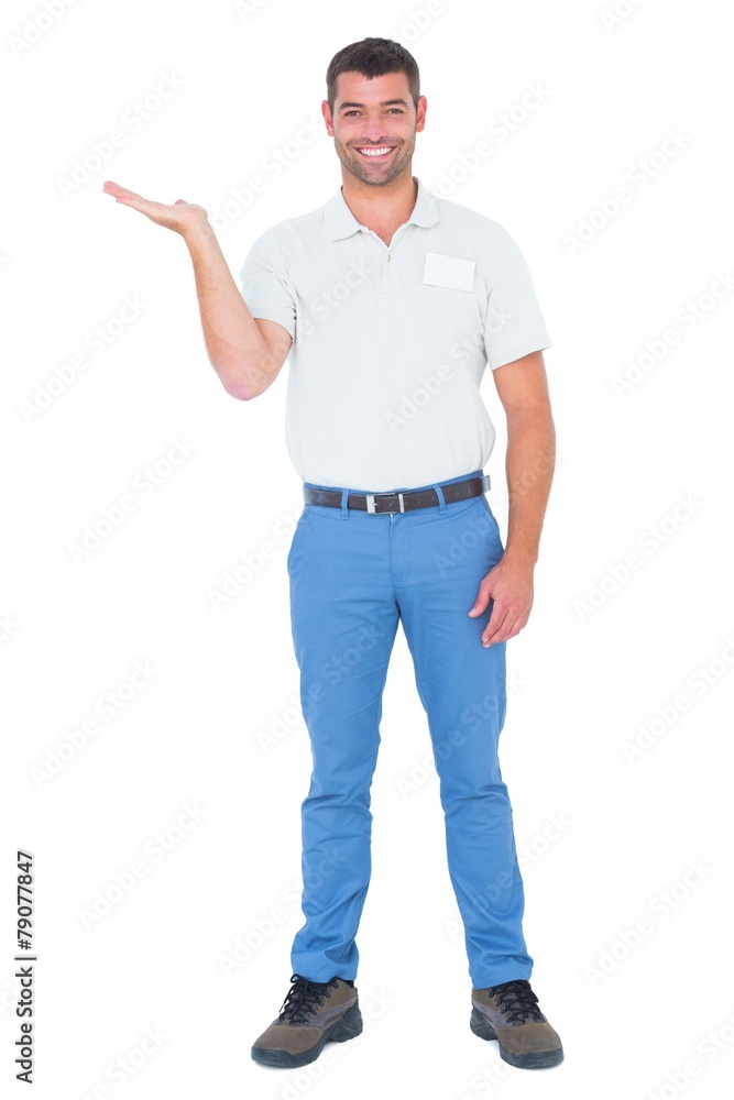 Salesman presenting in his palm against white background Salesman presenting in his palm against white background