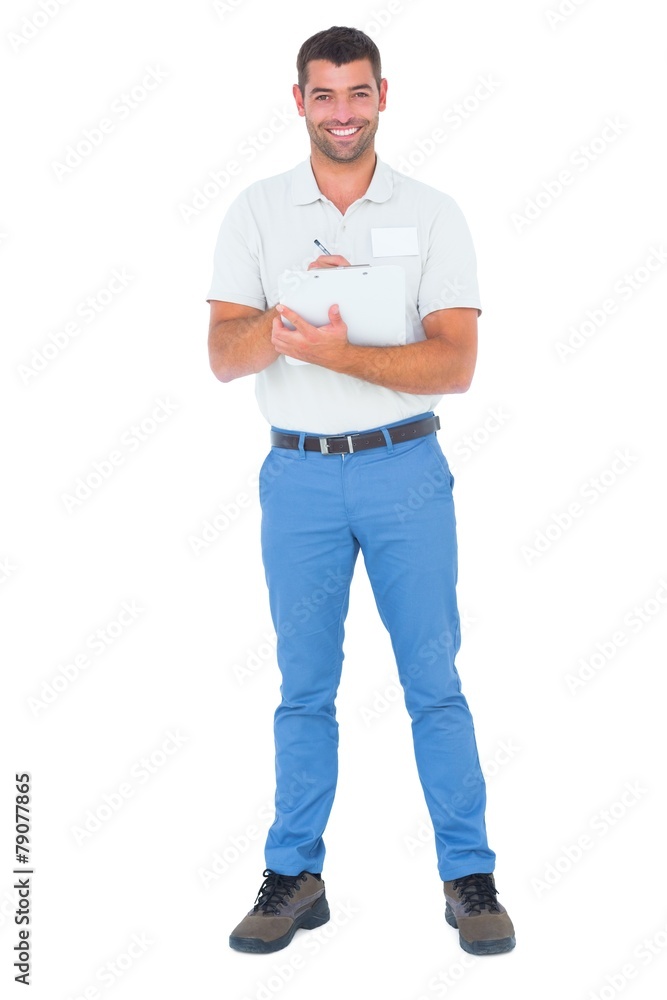 Confident male supervisor writing on clipboard Confident male supervisor writing on clipboard