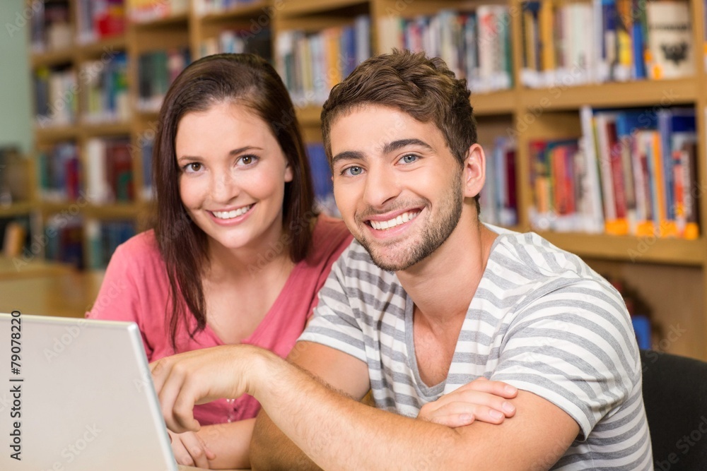 College students using laptop in library