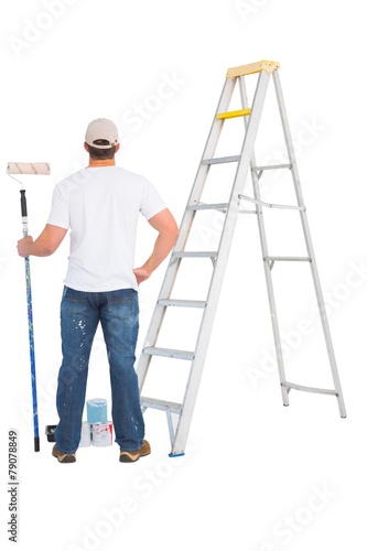 handyman with paint roller and ladder