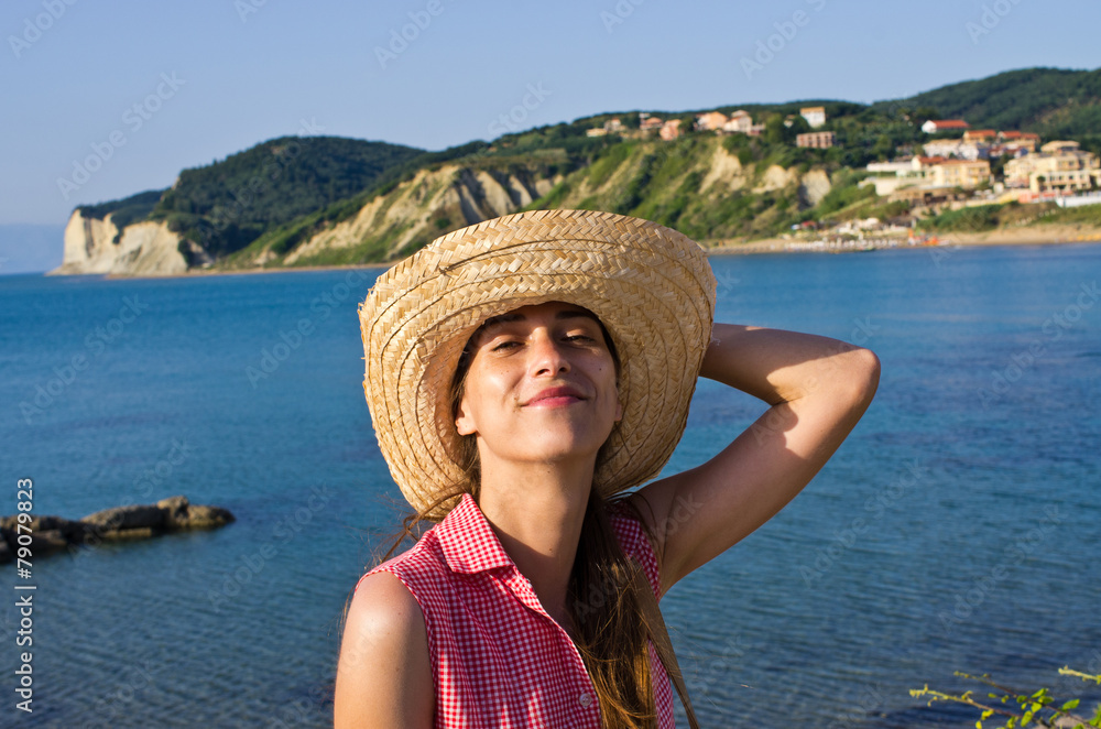 Young woman in hat enjoying vacation time