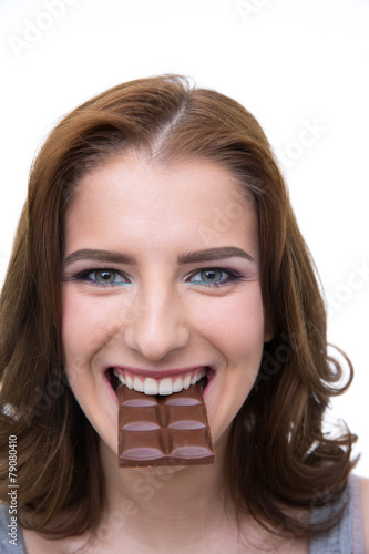 Happy woman biting in a chocolate tablet