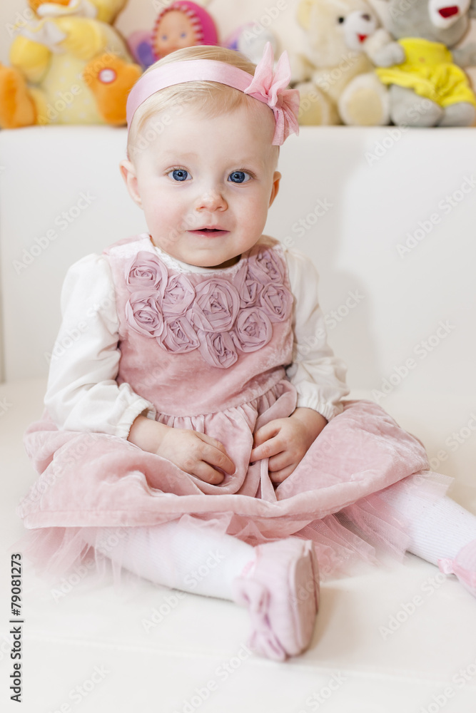 portrait of sitting toddler girl wearing pink dress portrait of sitting toddler girl wearing pink dress