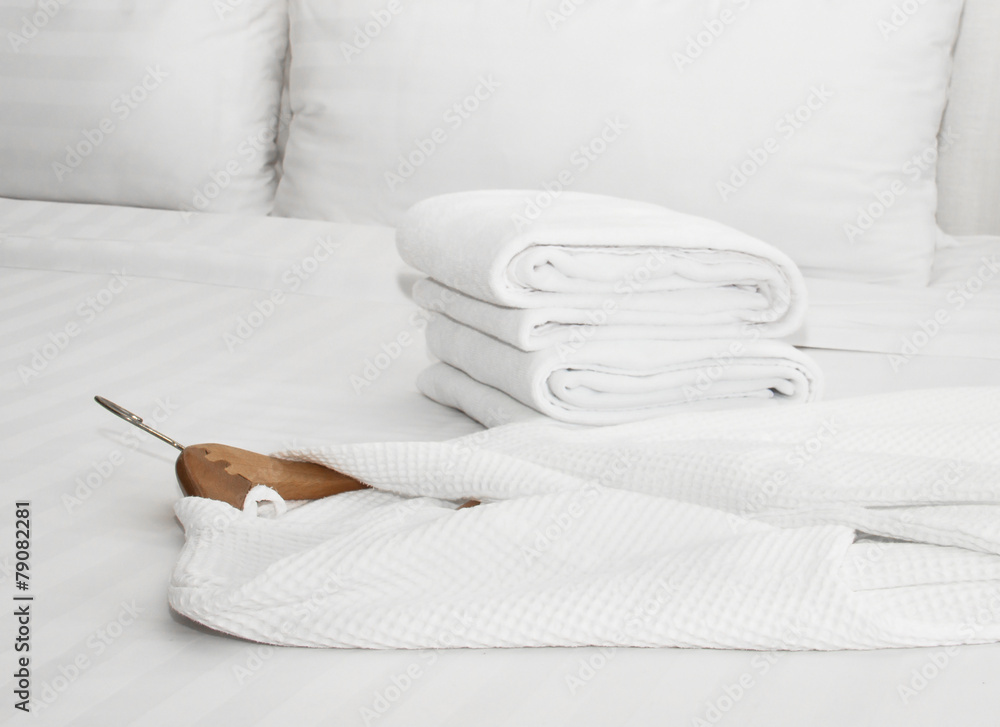 white bathrobe on the bed - obrazy, fototapety, plakaty 