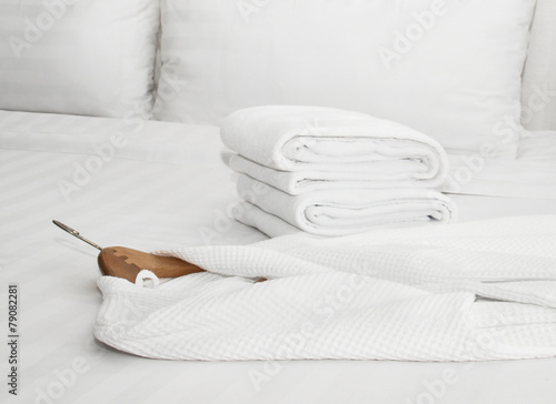 white bathrobe on the bed