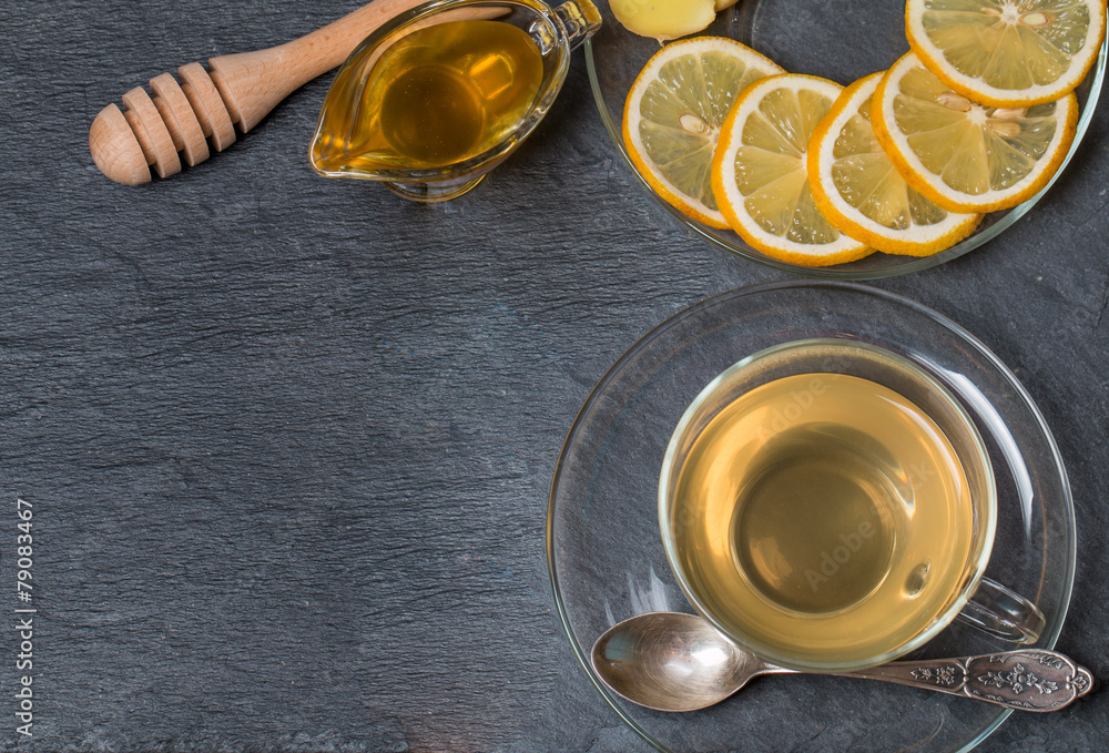 Cup of ginger tea with honey and lemon on wooden table Cup of ginger tea with honey and lemon on wooden table