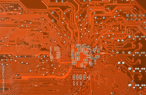 Close up of a printed orange computer circuit board photo