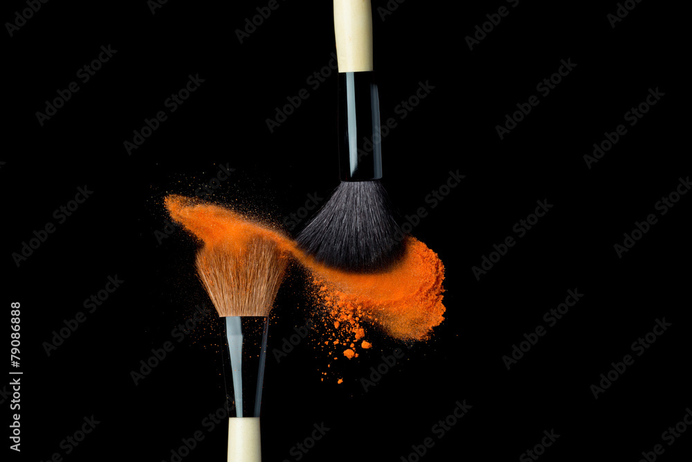 powderbrush on black background with blue powder splash Stock Photo