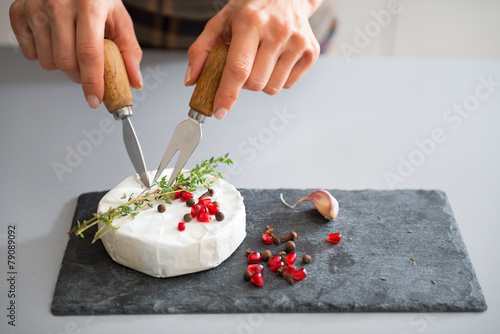 Closeup on young woman eating camembert photo