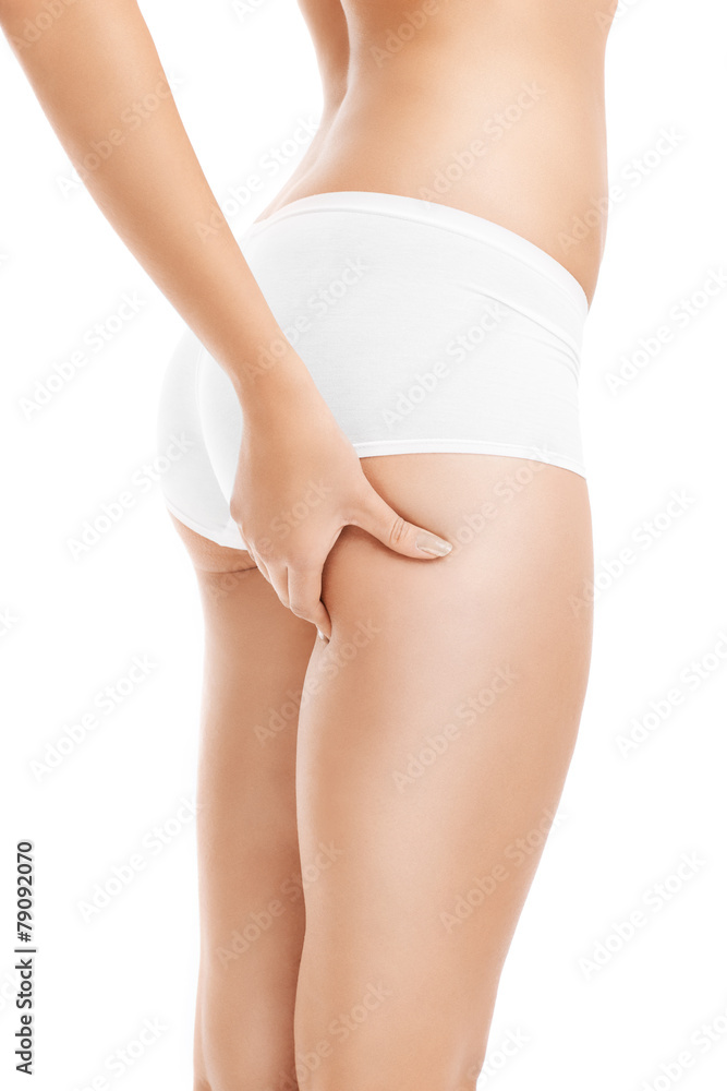 Woman checking cellulite on her thigh