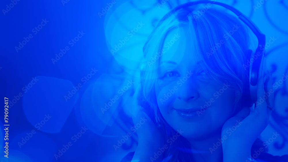 Fototapeta premium Pretty young woman listening to music, headphones