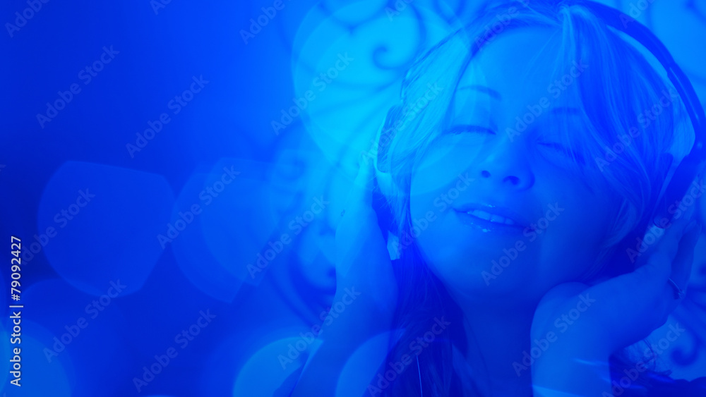 Attractive young woman with headphones blue abstract background