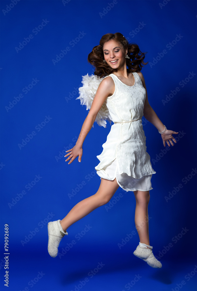 Naklejka premium Angel girl in motion on a blue background. ecological concept