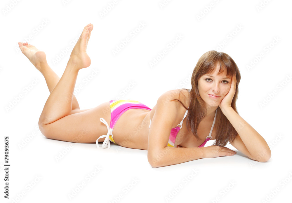 Obraz premium Slim woman dressed in swimmsuit tanning on the beach.