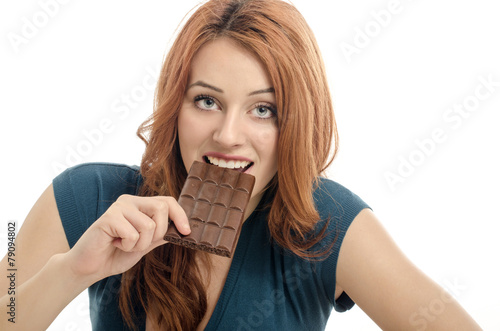 Happy woman eating a yummy chocolate and having some sugar