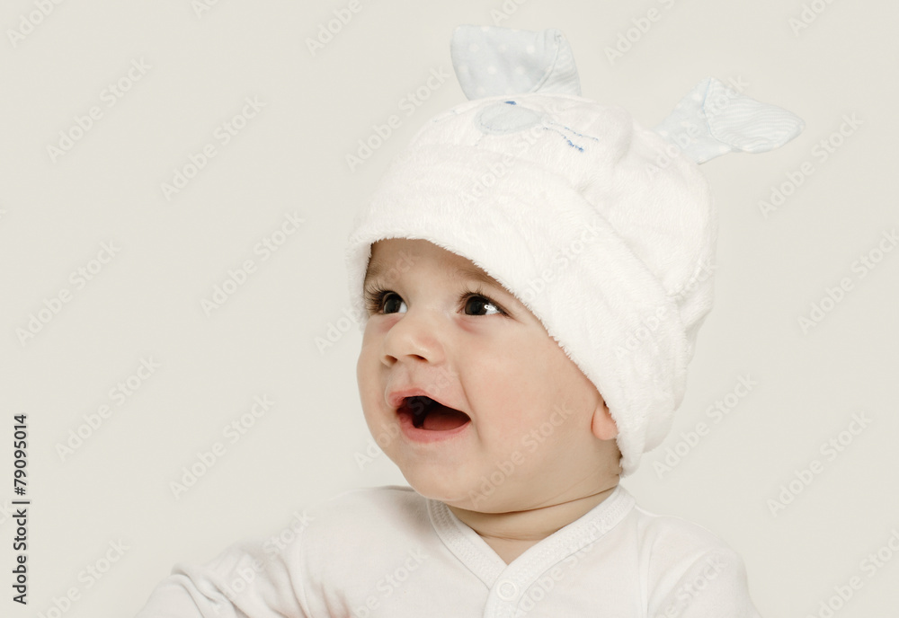 Innocent baby wearing a white bunny hat looking adorable. Innocent baby wearing a white bunny hat looking adorable.
