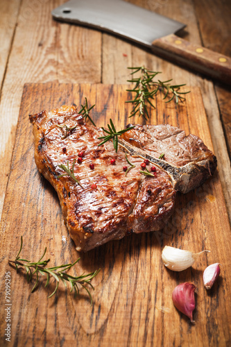 Fiorentina steak grilled with spices and vegetables on a rustic