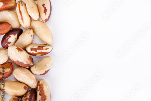 Five big, beautiful, Brazilian walnut on a white background.