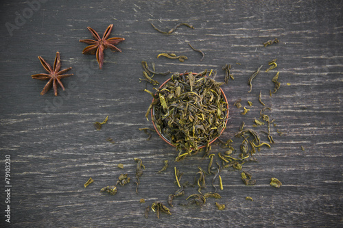 dry green tea on wooden background photo