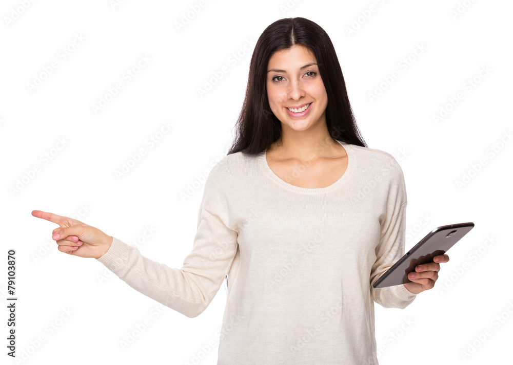 Mixed indian woman hold with tablet and finger point aside Mixed indian woman hold with tablet and finger point aside