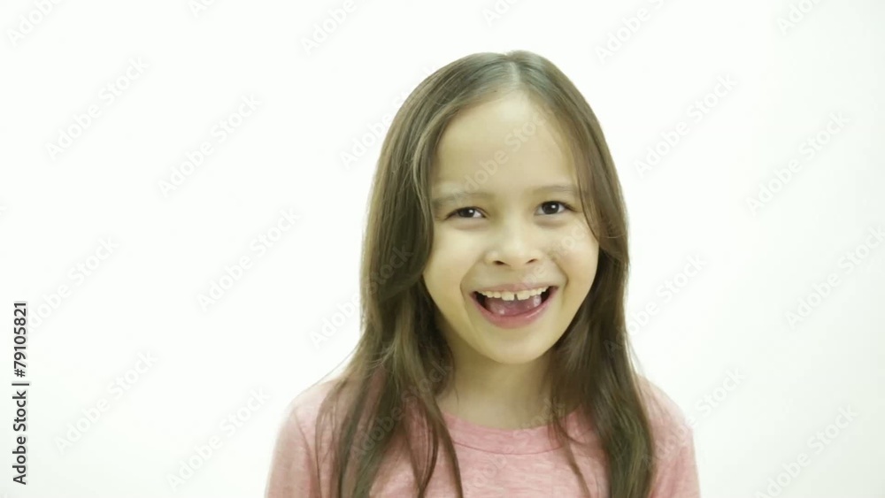 Young girl laughing expressively and holding her hands to her mo Young girl laughing expressively and holding her hands to her mo