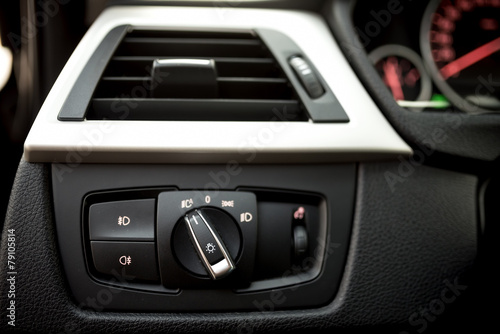 Air conditioning of automobile interior and headlight controls