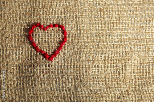 Linen canvas with red heart embroidered on it  close-up